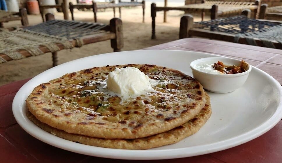 hot tandoori parathas with white butter and curd at a roadside dhaba in murthal on the delhi amritsar highway.