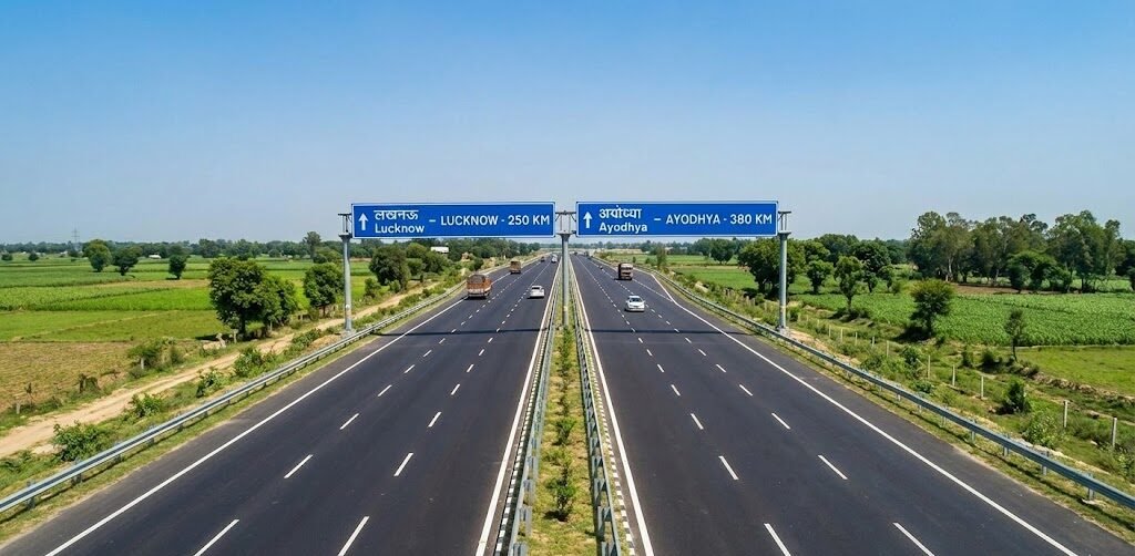 wide view of the smooth, six lane agra lucknow expressway showing overhead highway signs pointing towards lucknow and ayodhya.